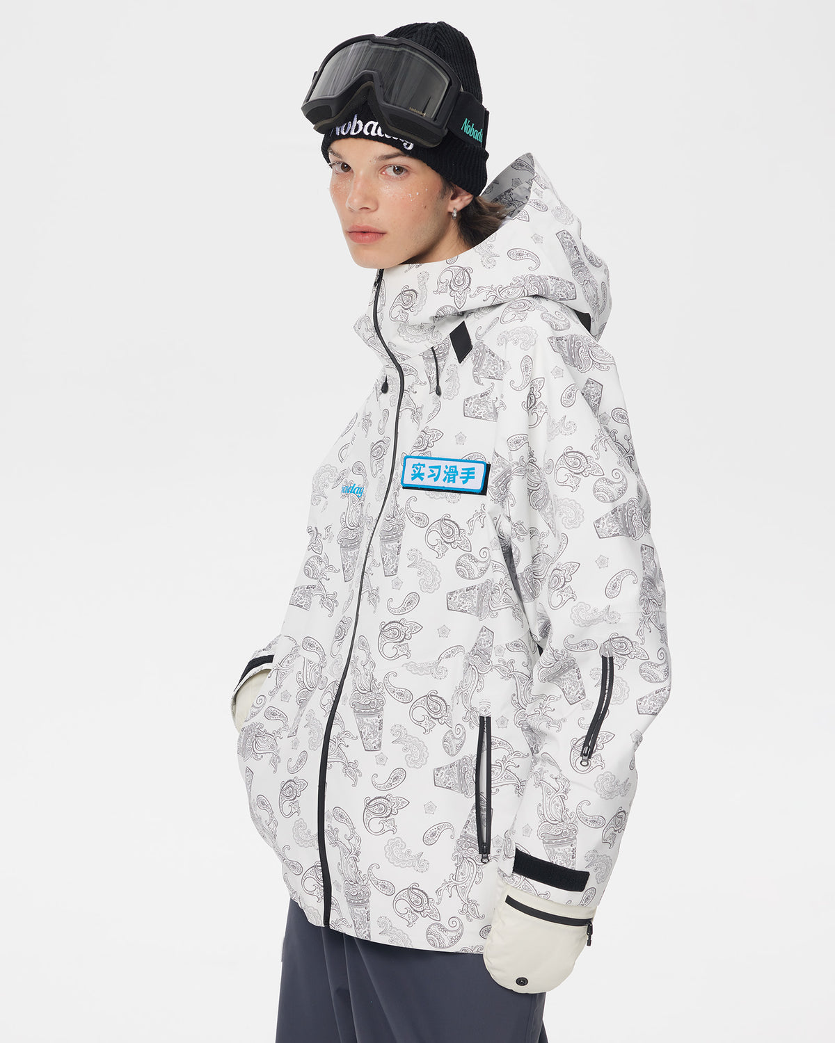 Half-body view of a model wearing the white paisley-print Nobaday Dawn Print 3L Zip-Up Snow Jacket