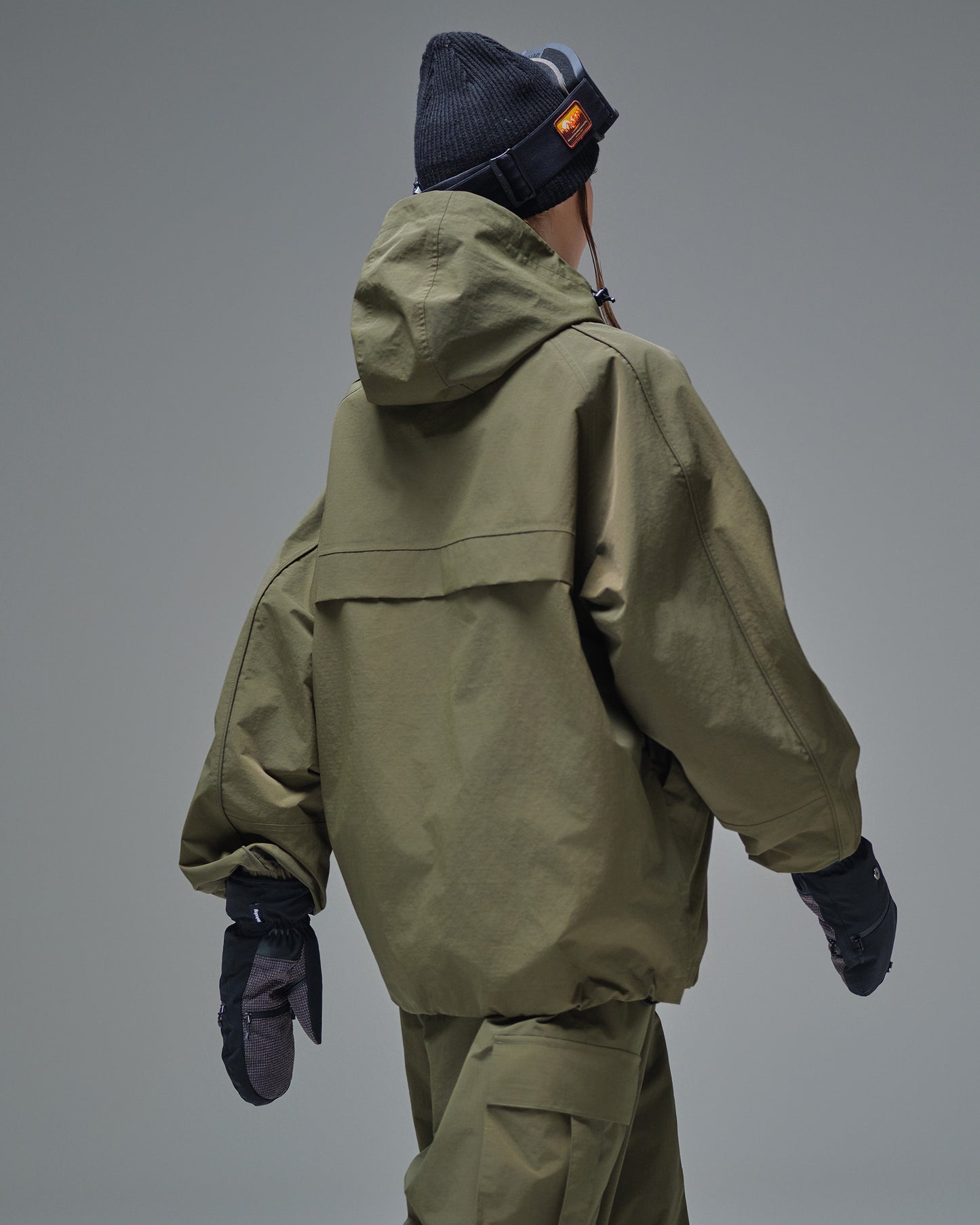 Back view of Nobaday green cargo snow jacket showing adjustable hood, relaxed fit, and wind-resistant waterproof shell