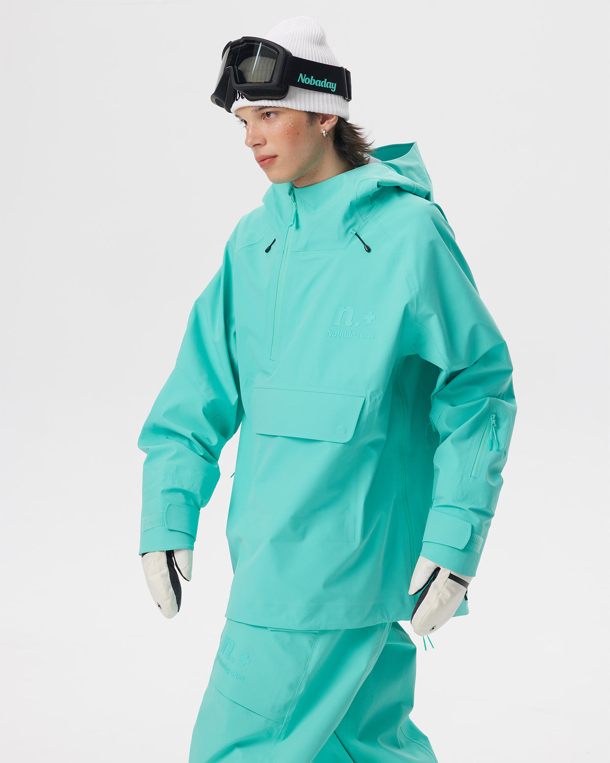 Male model wearing the Nobaday Men's ArcticStorm Freeride Auroral Blue 3L Anorak Jacket in a three-quarter action view