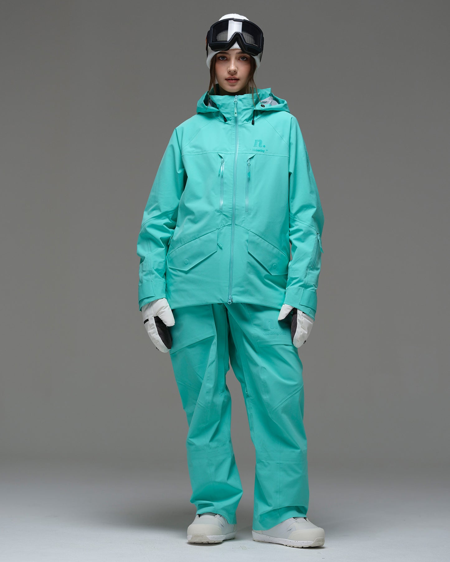 Full-body front view of the NOBADAY Women's ArcticStorm Freeride 3L blue waterproof snow jacket with matching snow pants