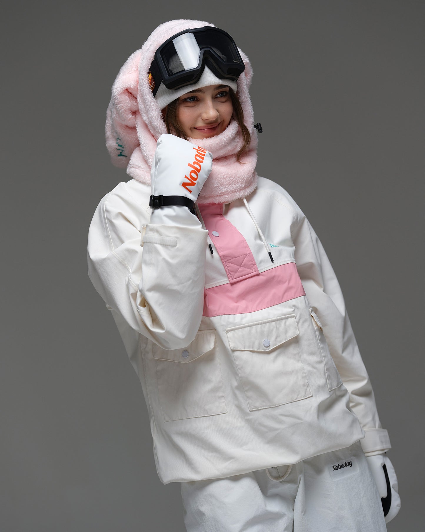 Model wearing the ivory and pink Nobaday Women’s Juicy Candy Retro Snow Jacket with front utility pockets