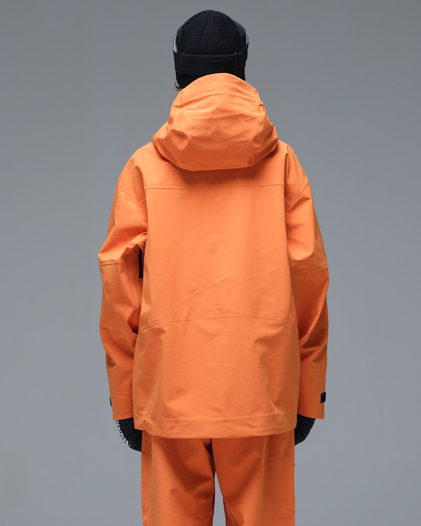 Back view of the NOBADAY Women's Pure Free 3L orange snow jacket showing the protective hood and clean rear design