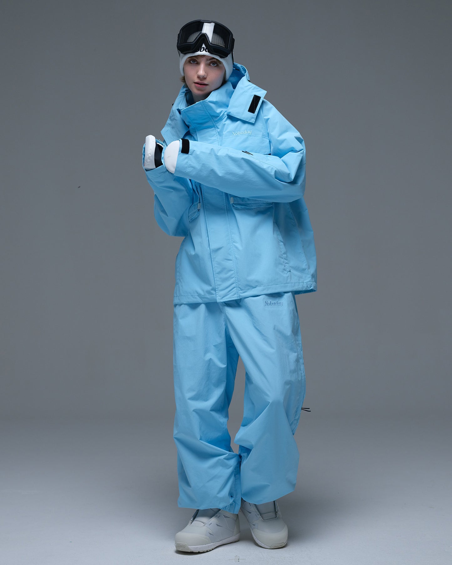 Full-body view of the sky blue Nobaday Women’s Pure Free Drift Snow Jacket styled with matching blue snow pants
