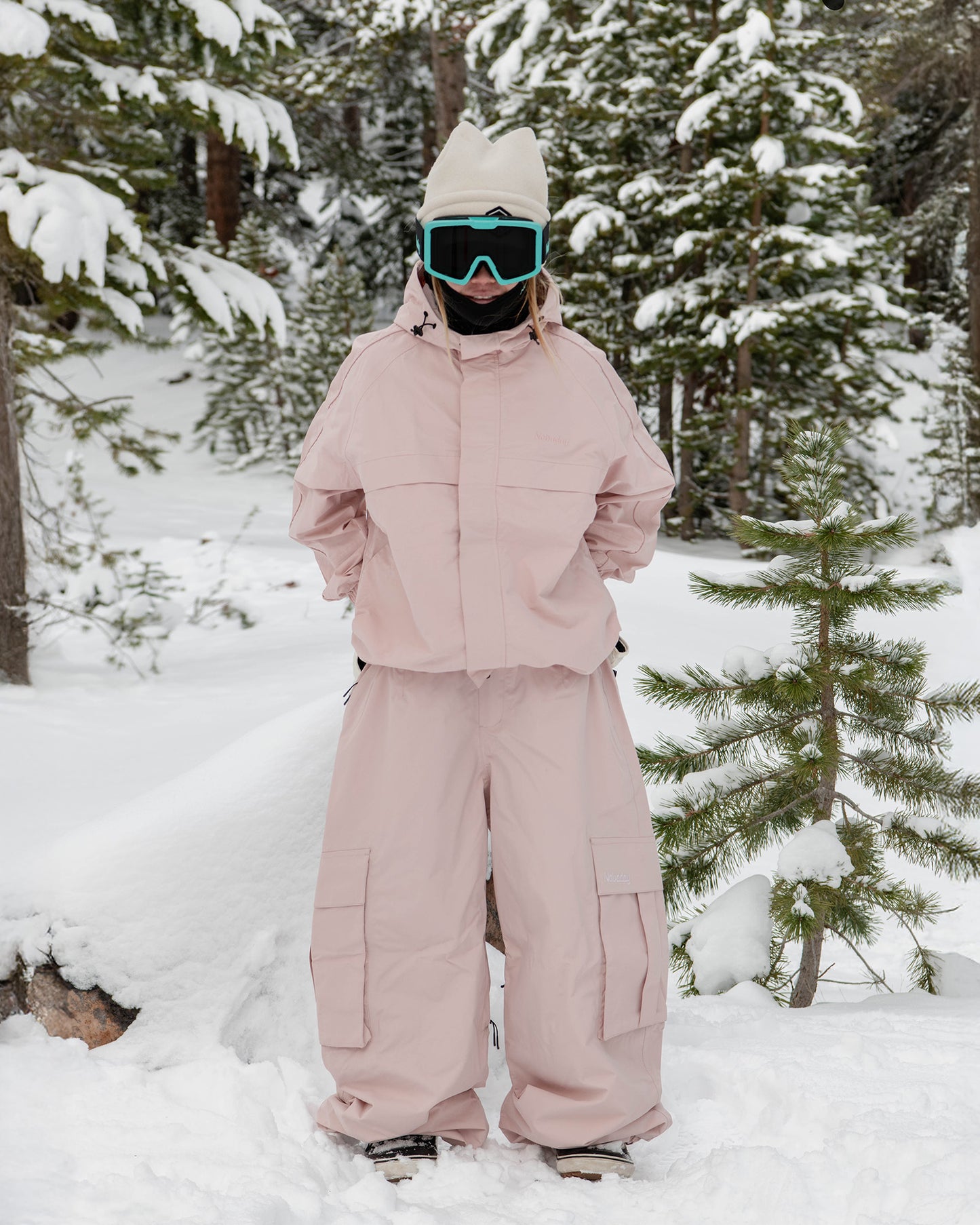 Woman wearing the Nobaday Women's Pure Free Snow Jacket in pink in a snowy forest