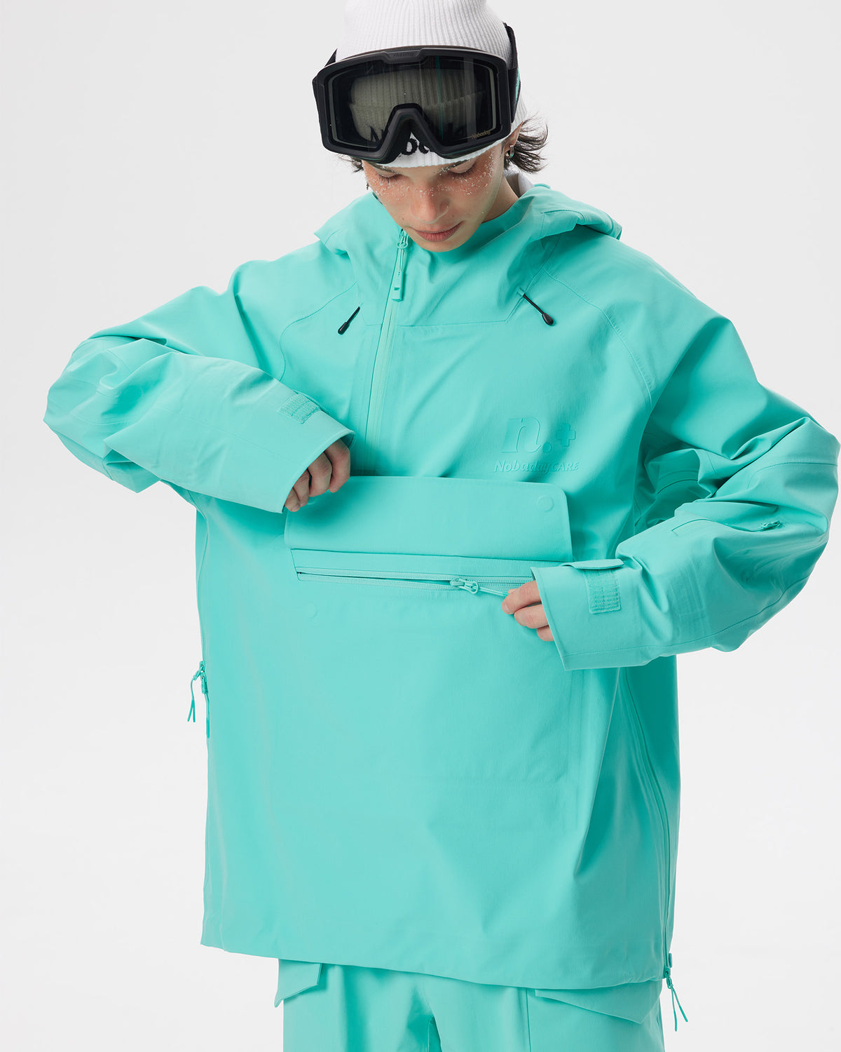 Close-up of the large front storage pocket on the Nobaday ArcticStorm Freeride Auroral Blue 3L Anorak Jacket