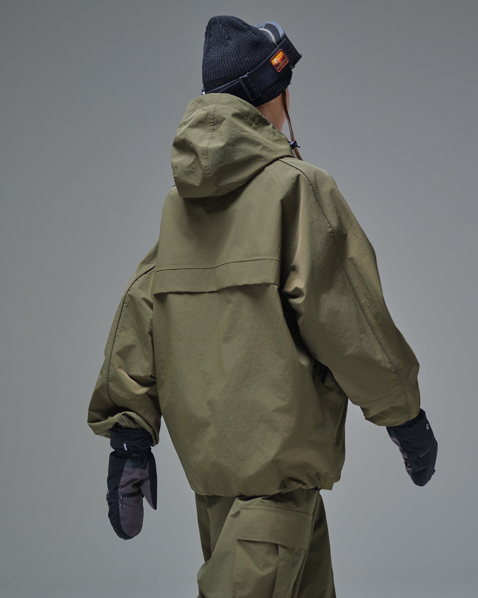 Back view of Nobaday green cargo snow jacket showing adjustable hood, relaxed fit, and wind-resistant waterproof shell