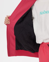 Interior close-up of the Nobaday Juicy Dark Red Jacket showing its black quilted insulation and ribbed hem