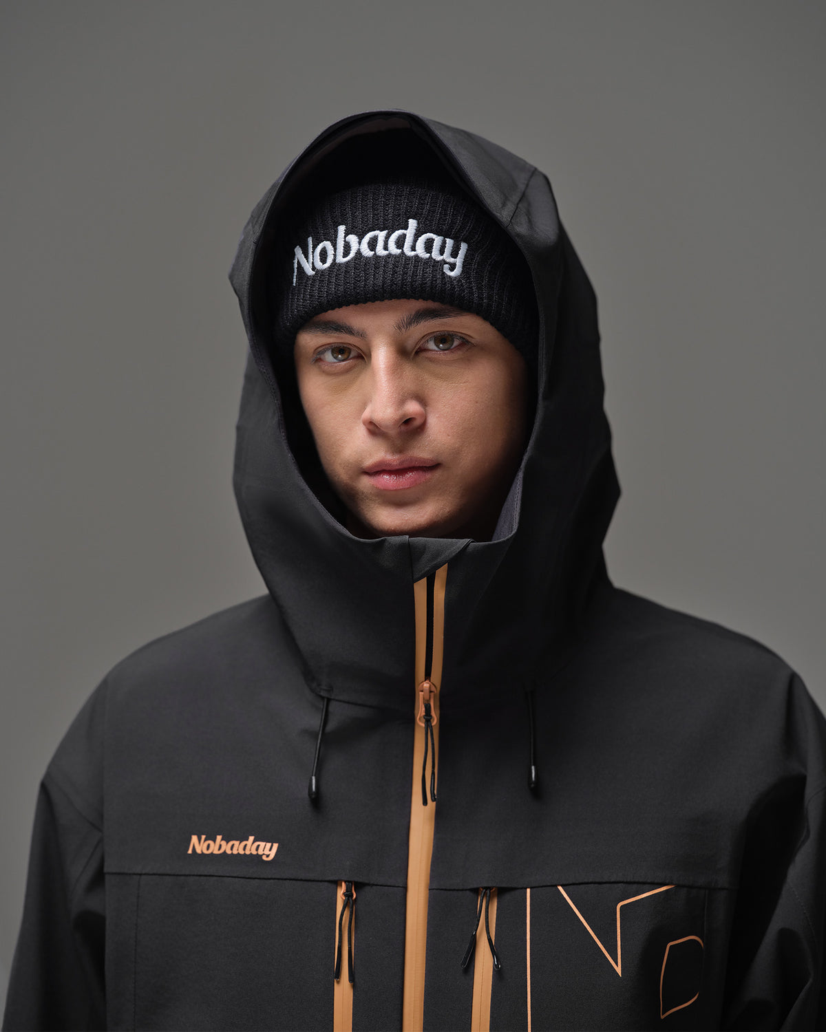 Close-up of the adjustable hood and high collar on the black NOBADAY Apex 3L snow jacket