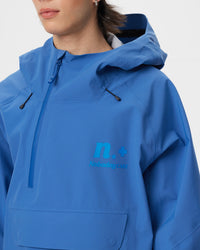 Close-up of the high collar, half-zip closure, adjustable hood and Nobaday Care logo on the blue ArcticStorm 3L Anorak Snow Jacket