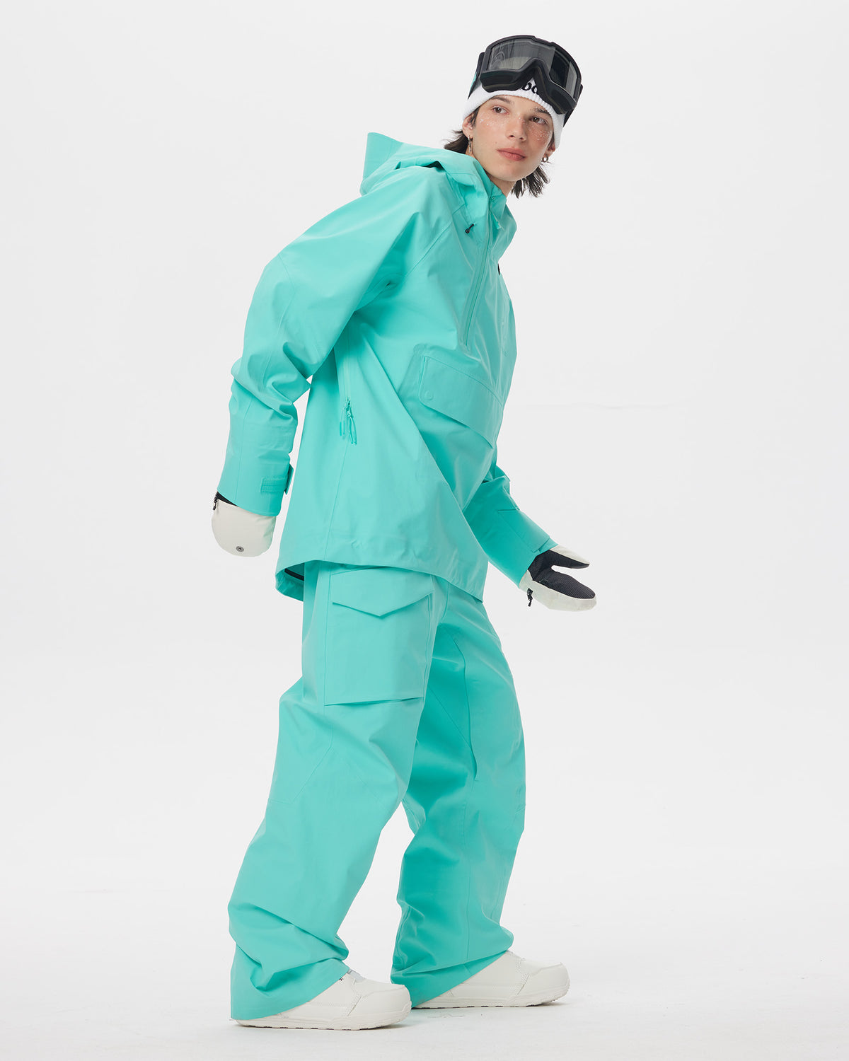 Full-body action view of a male model wearing the Nobaday ArcticStorm Freeride Auroral Blue 3L Anorak Jacket and matching snow pants