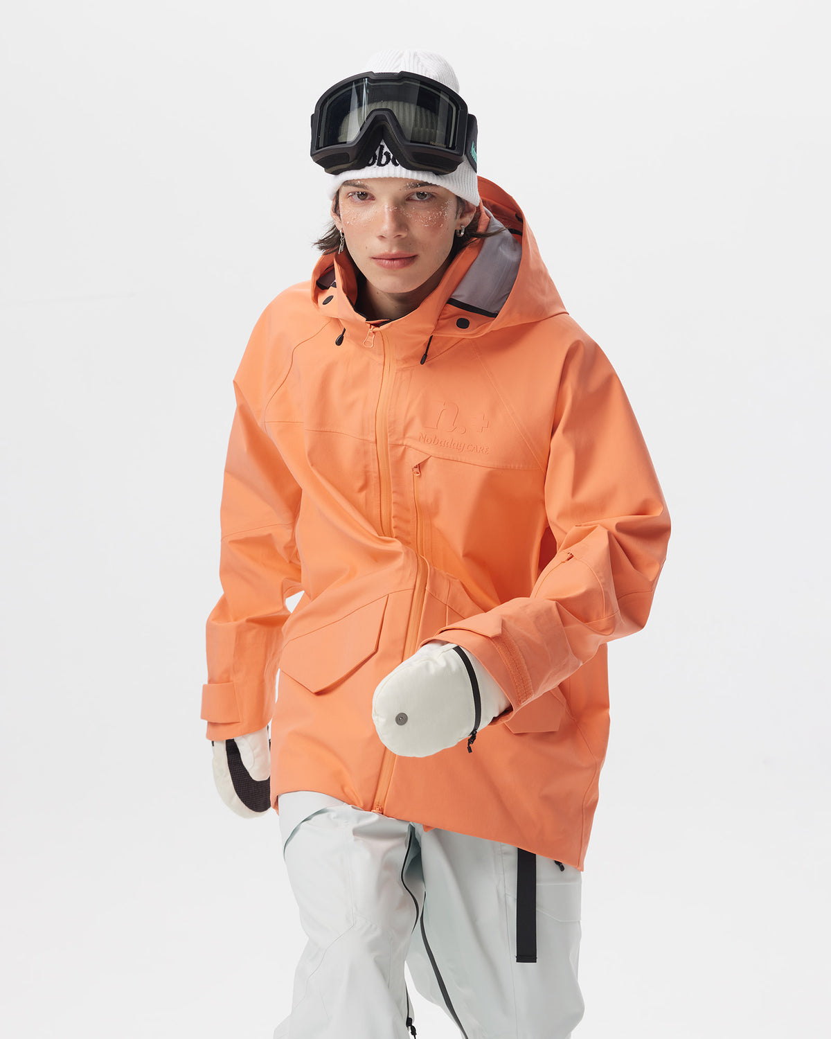 Male model posing in the Nobaday Men's ArcticStorm Freeride Orange 3L Snow Jacket, showing the front pockets and loose fit