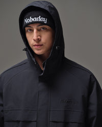 Close-up of the adjustable hood and high collar on the black NOBADAY men’s snow jacket