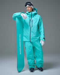 Man wearing the Nobaday Blue Apex 3L snow jacket and matching pants while holding a snowboard