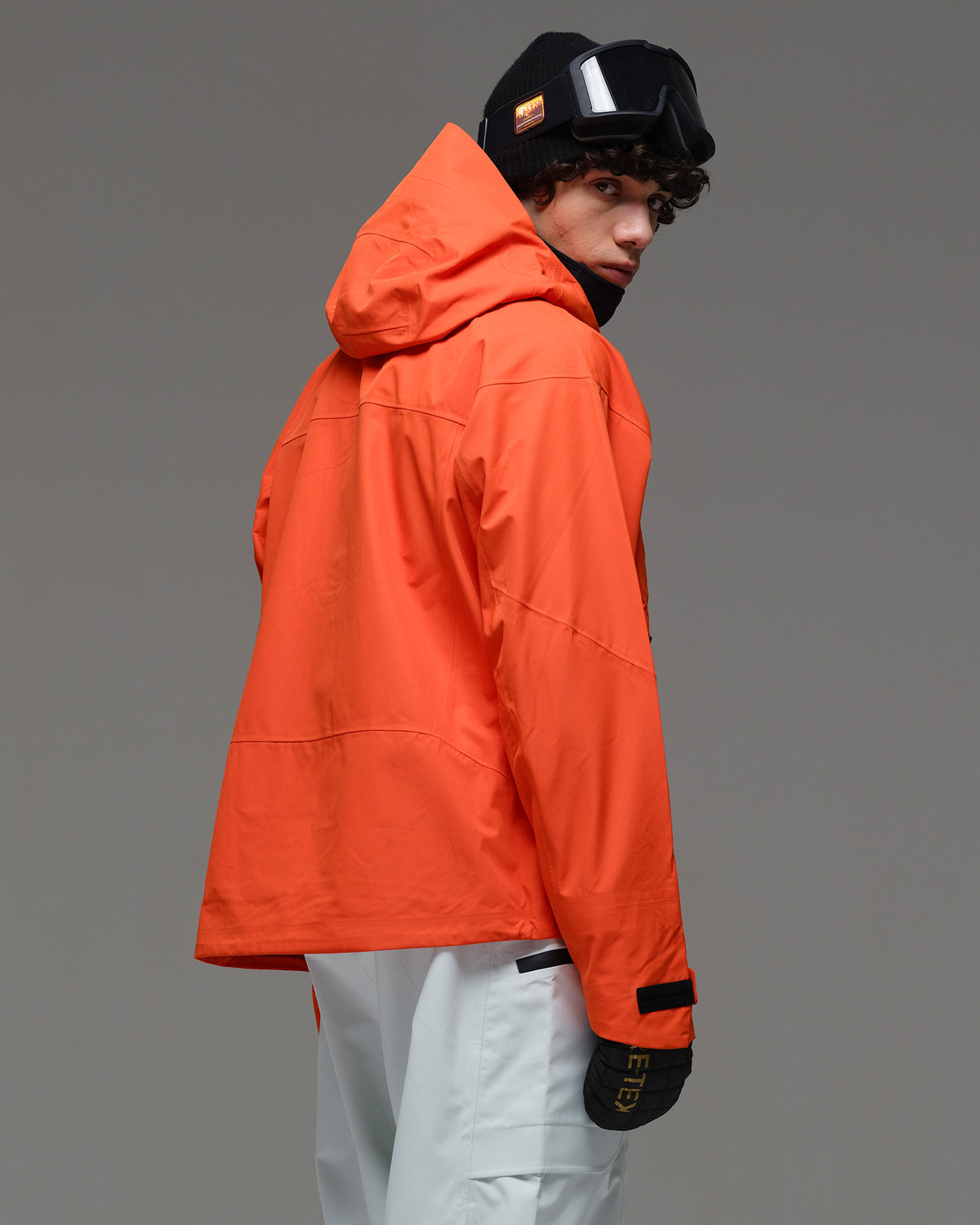 Back view of the NOBADAY Men’s MaxExtreme Pro 3L snow jacket in orange showing the hood and relaxed fit