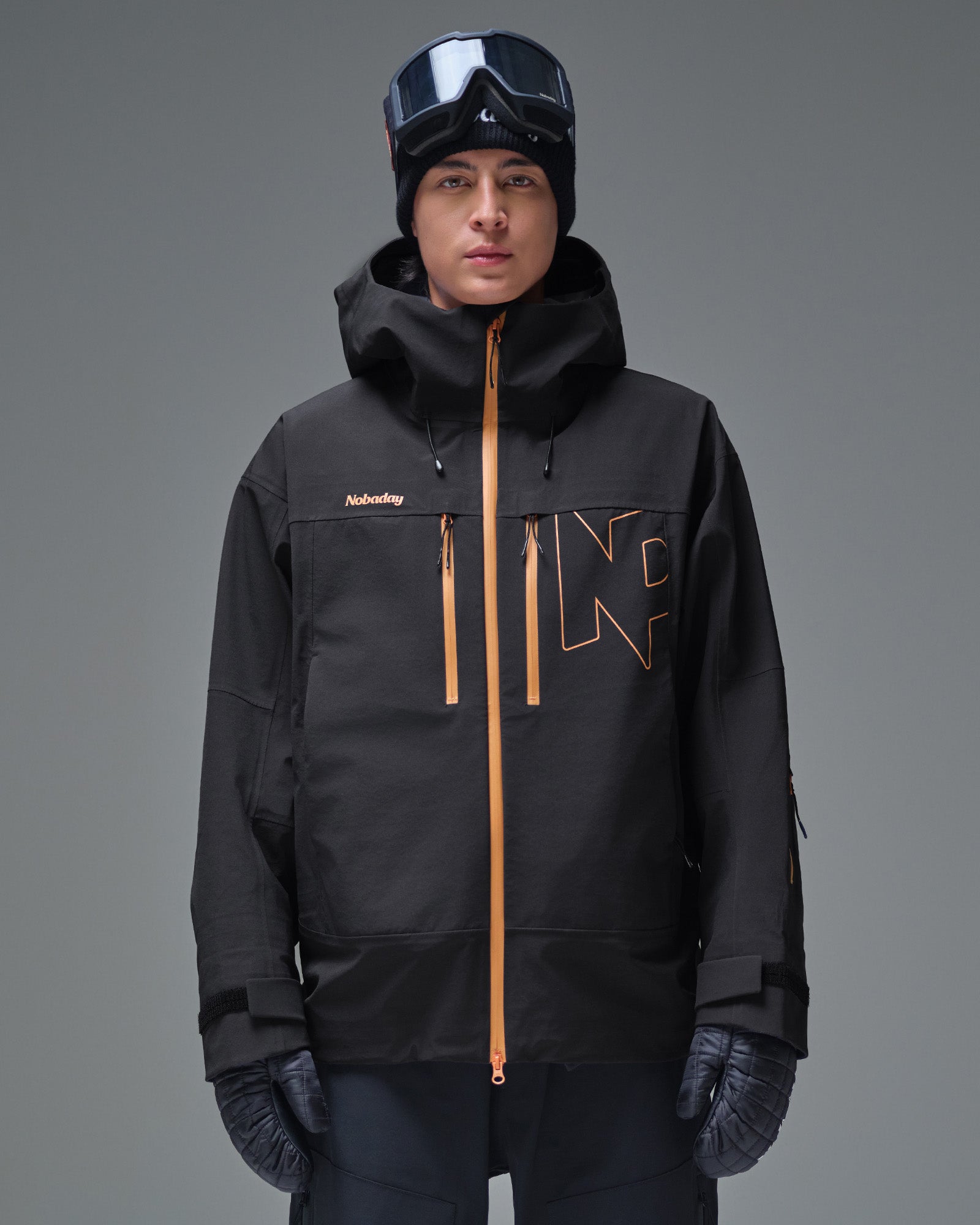 Front view of the black NOBADAY Pure Free Apex 3L snow jacket with orange waterproof zippers