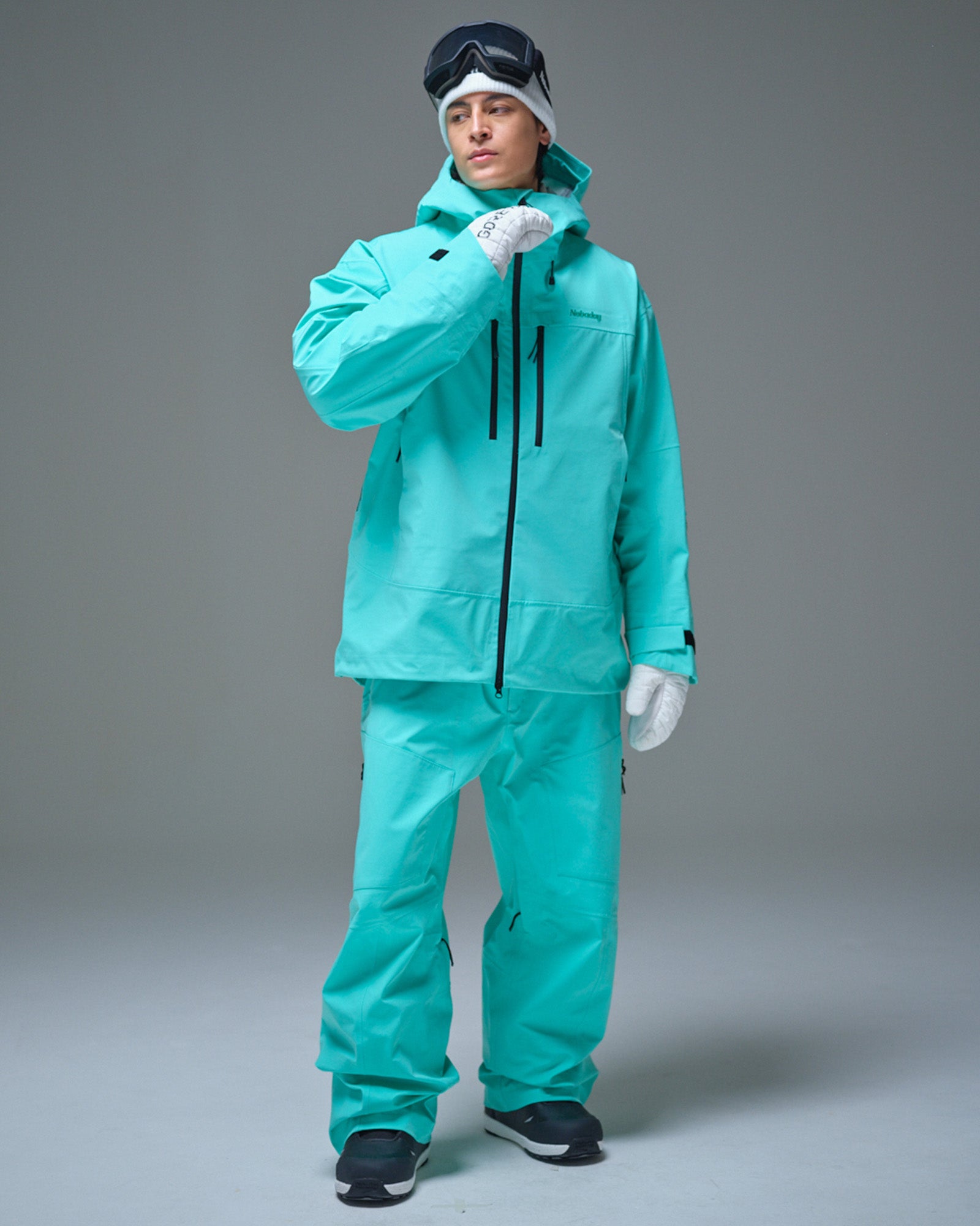 Full-body view of a man wearing the Nobaday Blue Apex 3L snow jacket with matching snow pants