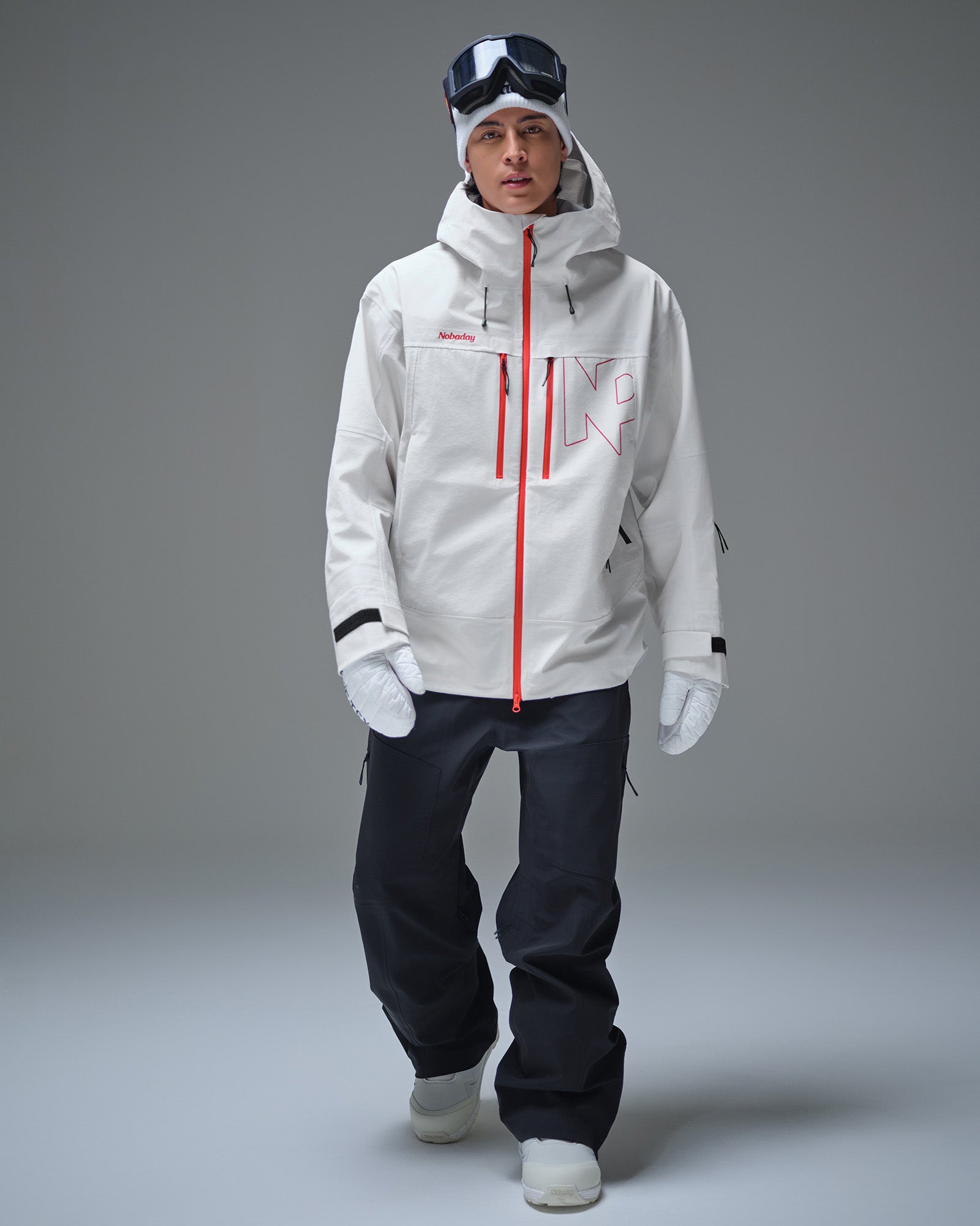 Full-body lifestyle view of a man wearing the white NOBADAY Pure Free Apex 3L snow jacket