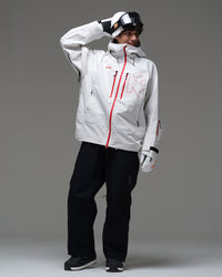 Full-body lifestyle view of a man wearing the white NOBADAY Pure Free Apex 3L snow jacket