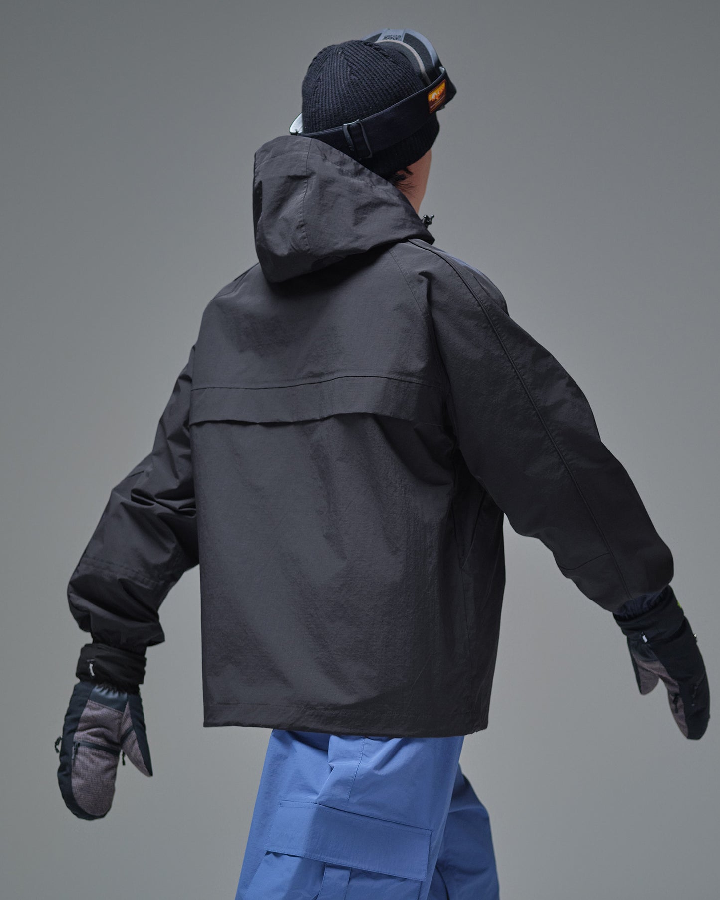 Back view of the black NOBADAY Pure Free snow jacket with an adjustable hood
