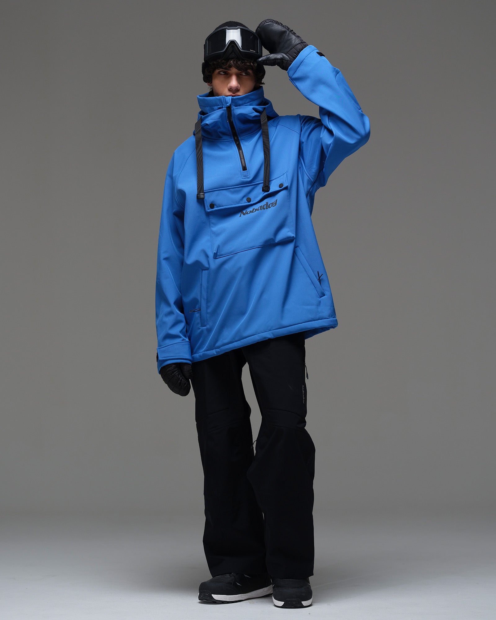 Full-body view of a man wearing the Deep Blue NOBADAY waterproof fleece hoodie with black snow pants