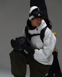 Man wearing a white NOBADAY Pure Free snow jacket with snowboard gear and a helmet