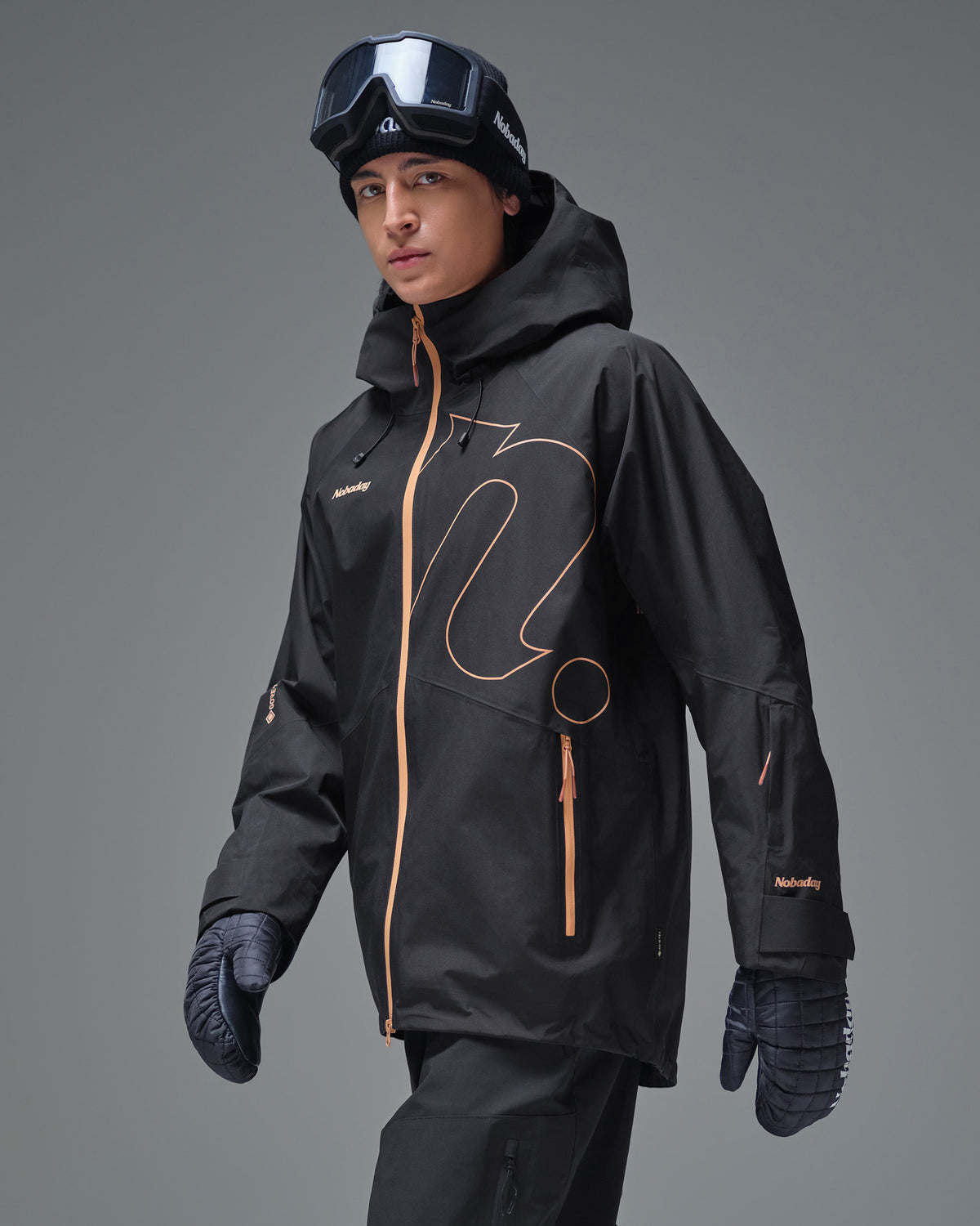 Side view of the Black NOBADAY Men’s Summit GORE-TEX snow jacket with orange zippers and hood