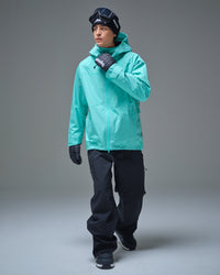 Full-body view of a man wearing the NOBADAY Men’s Summit GORE-TEX snow jacket in Nobaday Blue with black snow pants
