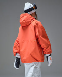 Back view of Nobaday orange active snow jacket showing oversized hood, relaxed fit, waterproof shell, and white snow pants