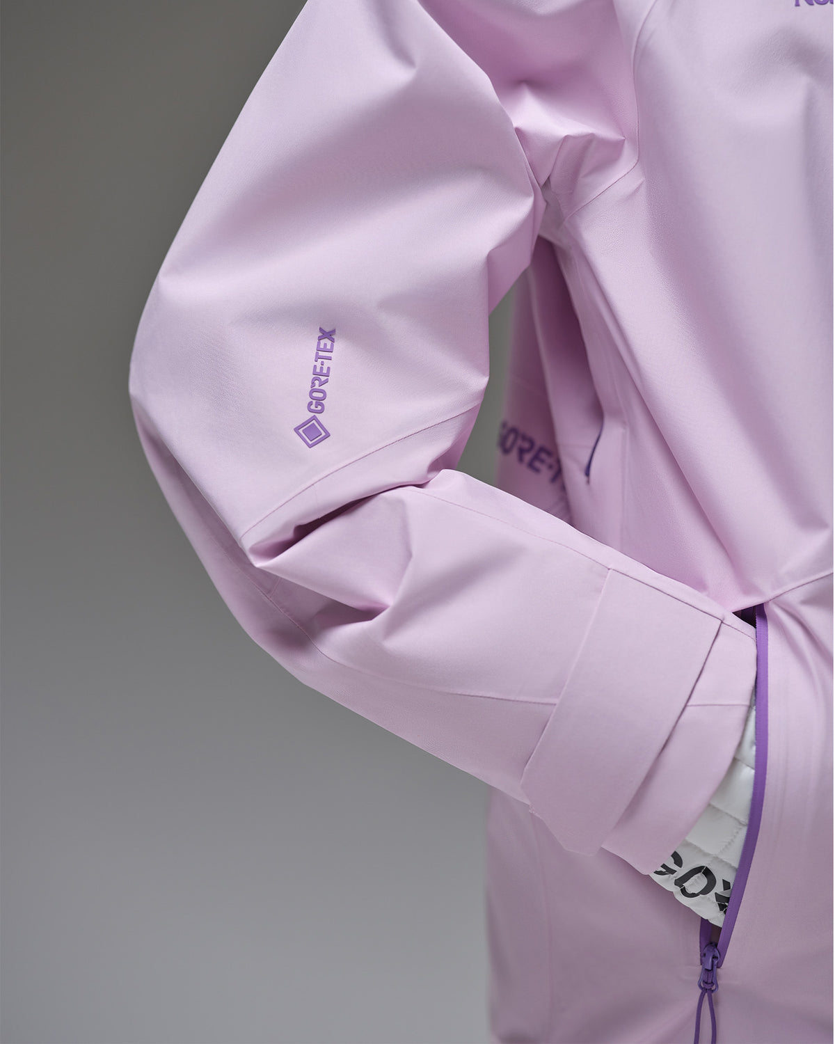 Close-up of the GORE-TEX sleeve logo and adjustable cuff on a pink NOBADAY snow jacket