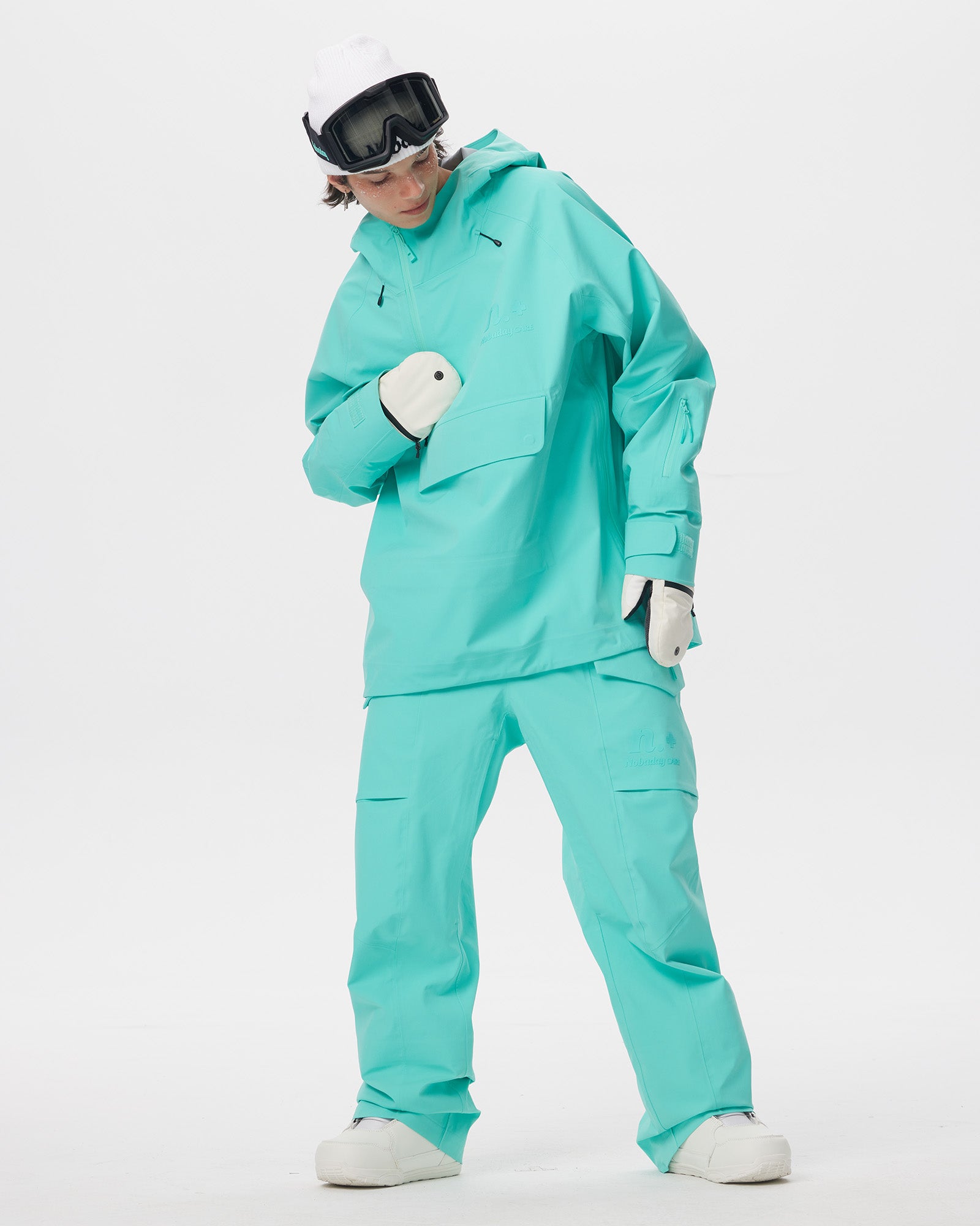 Male model wearing the Nobaday Summer Auroral Blue Snow Jacket with matching snow pants in a full-body action view
