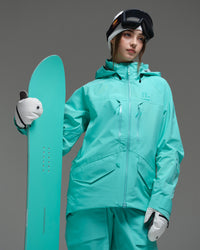 Woman wearing the NOBADAY Women's ArcticStorm Freeride 3L blue snow jacket while holding a matching snowboard