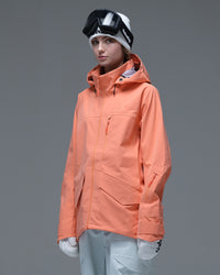 Front view of the coral orange Nobaday Women’s ArcticStorm Freeride Zip-Up 3L Snow Jacket featuring utility pockets and adjustable cuffs