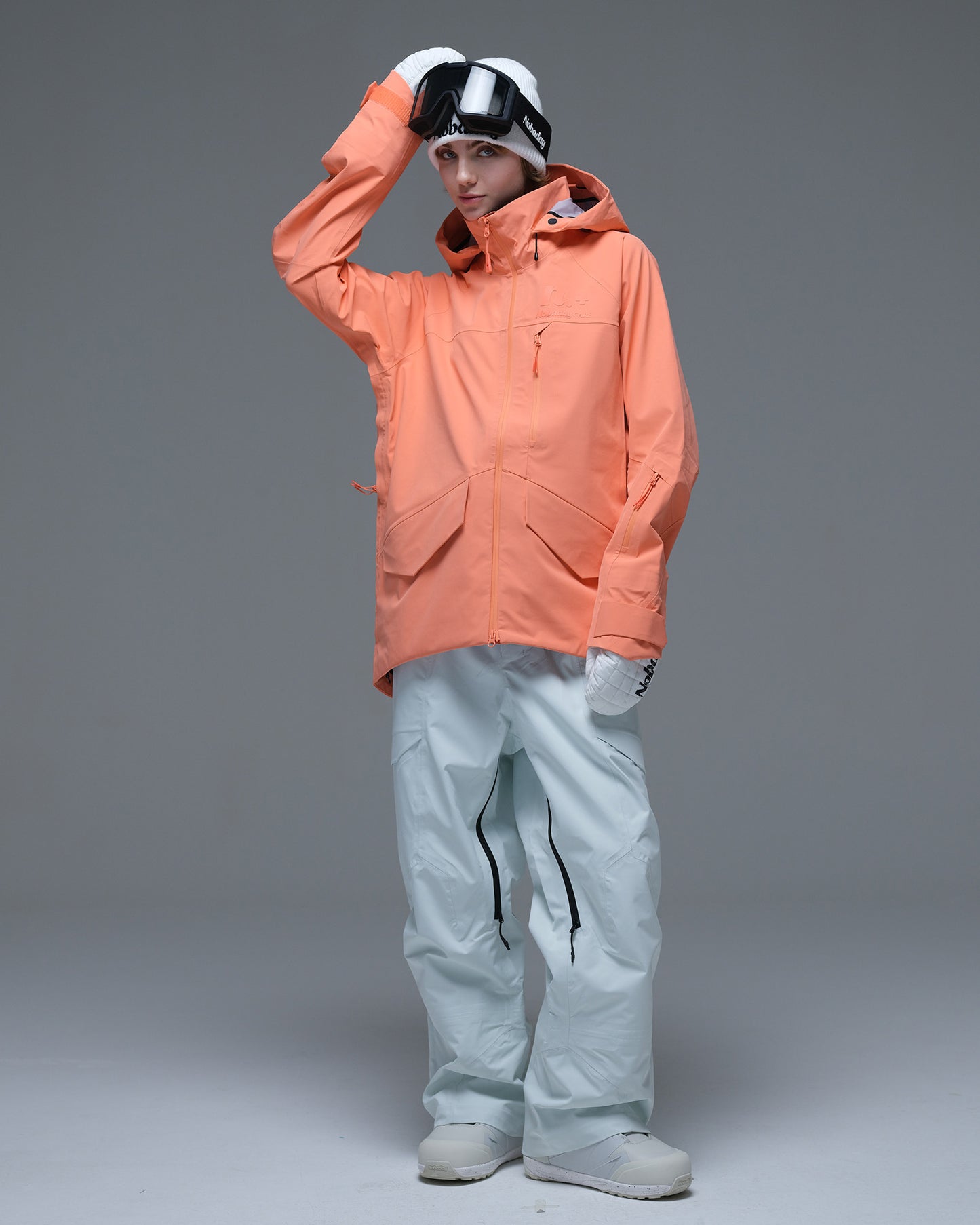 Full-body view of the coral orange Nobaday Women’s ArcticStorm Freeride Zip-Up 3L Snow Jacket featuring flap pockets and an adjustable hood