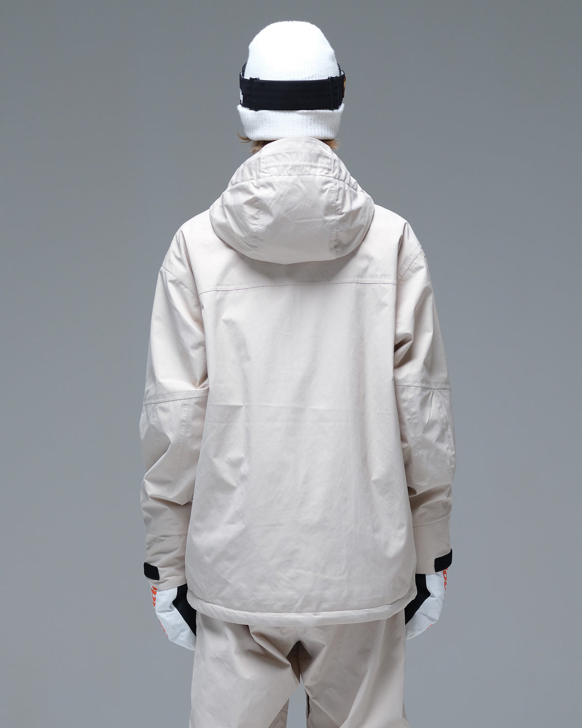 Back view of the NOBADAY Women's Baggy Insulated beige snow jacket showing its protective hood and loose-fitting silhouette