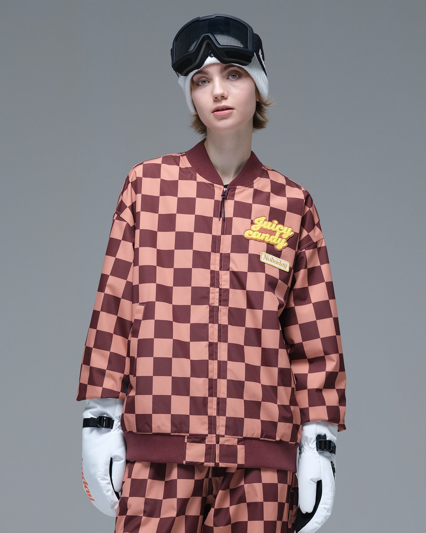 Front view of the brown and pink plaid Nobaday Women’s Baseball Insulated Snow Jacket featuring a baseball collar and embroidered chest patches