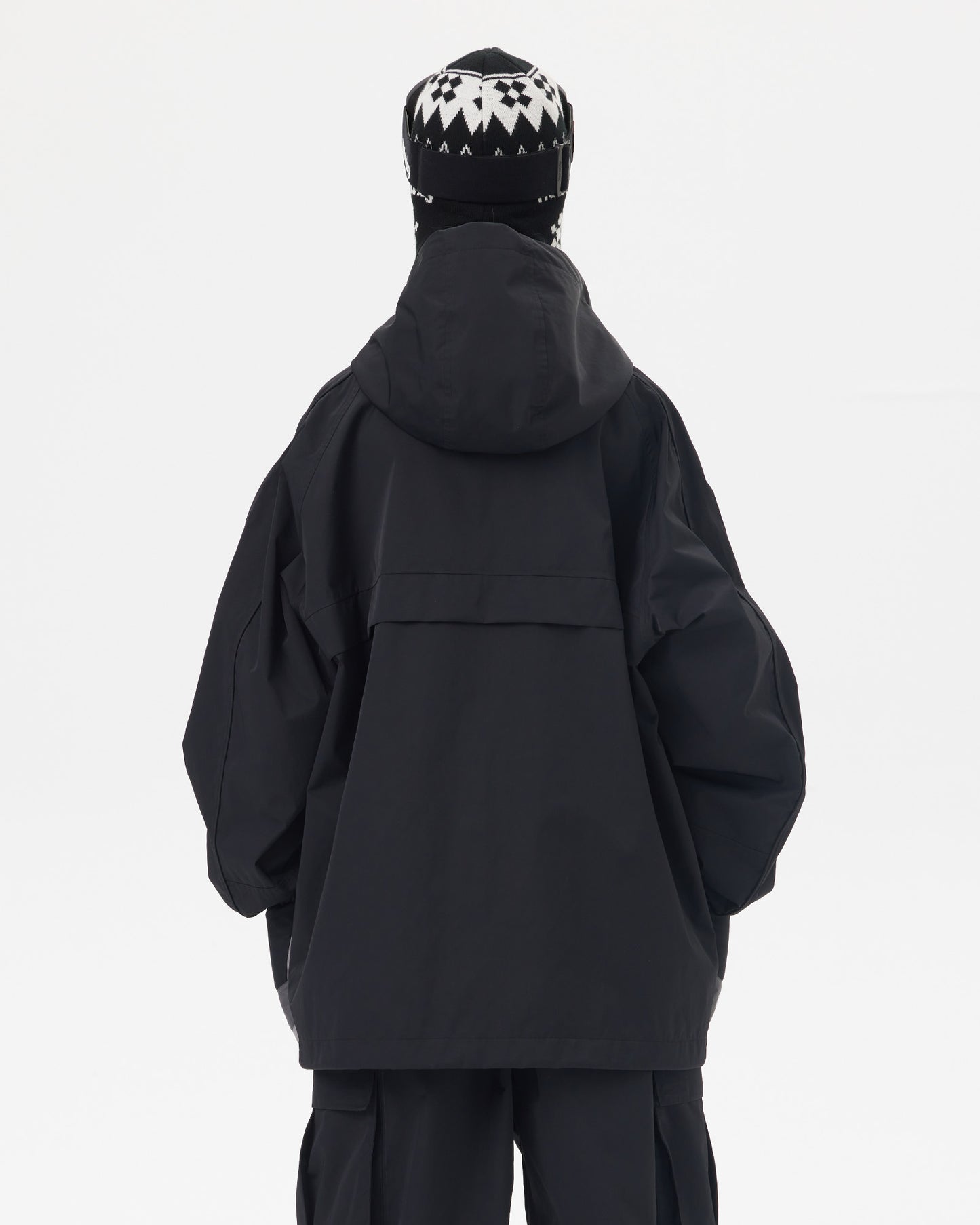 Back view of Nobaday women's black snow jacket showing oversized hood, longline fit, dropped shoulders, and waterproof shell fabric