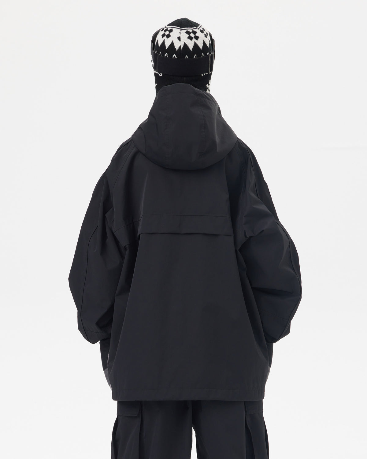 Back view of Nobaday women's black snow jacket showing oversized hood, longline fit, dropped shoulders, and waterproof shell fabric