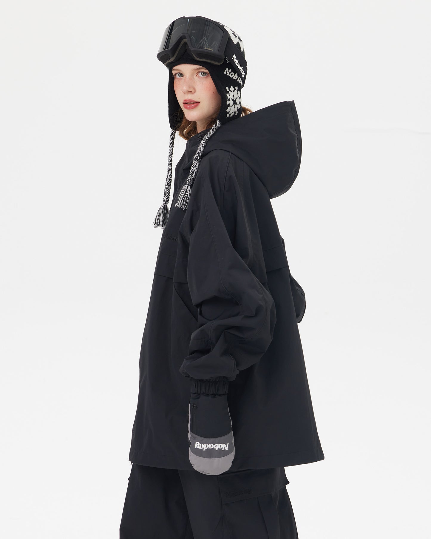 Side view of Nobaday women's black snow jacket with oversized hood, relaxed longline silhouette, elastic cuffs, and winter shell design