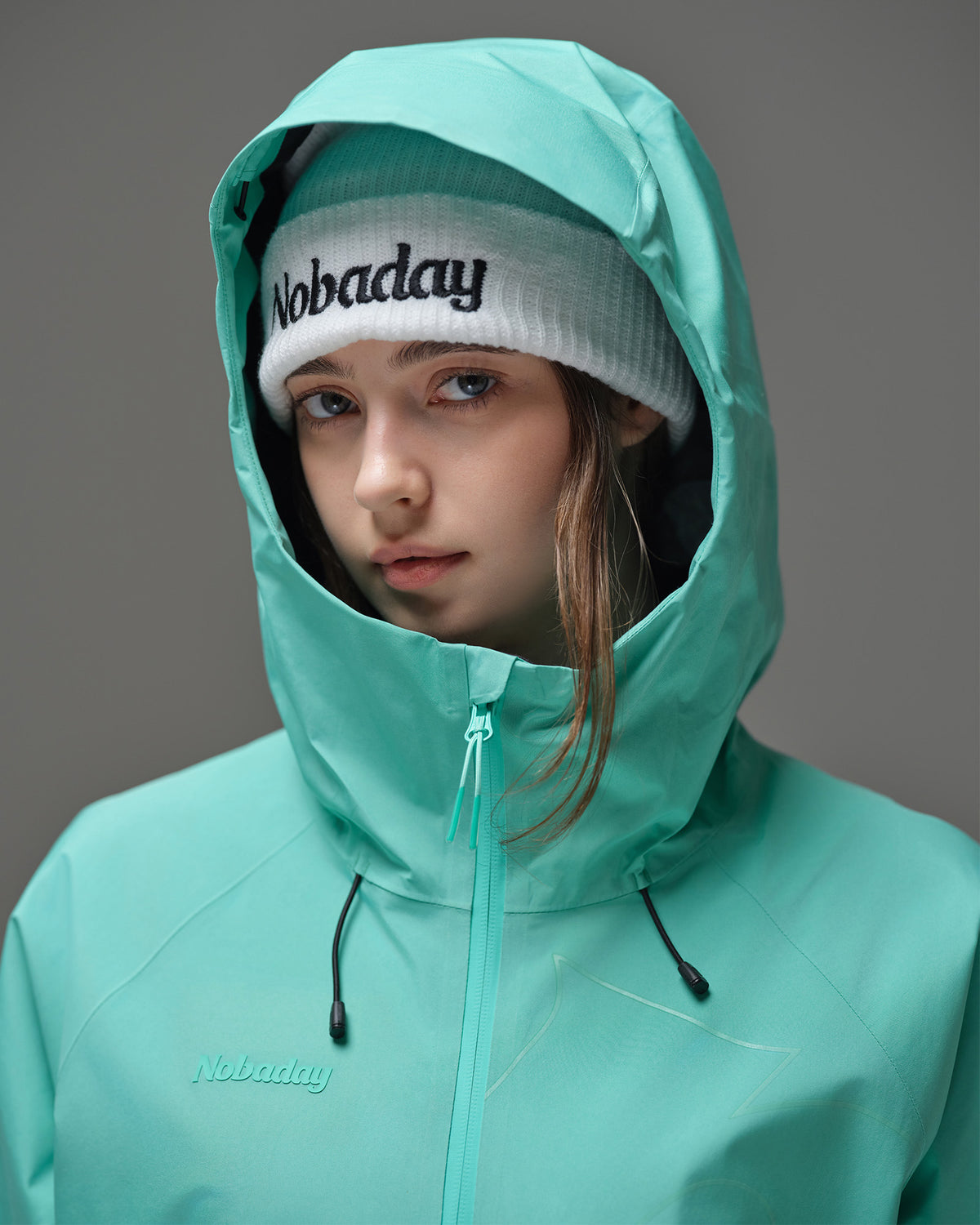 Close-up of the adjustable hood and high collar on a Nobaday Blue women’s snow jacket