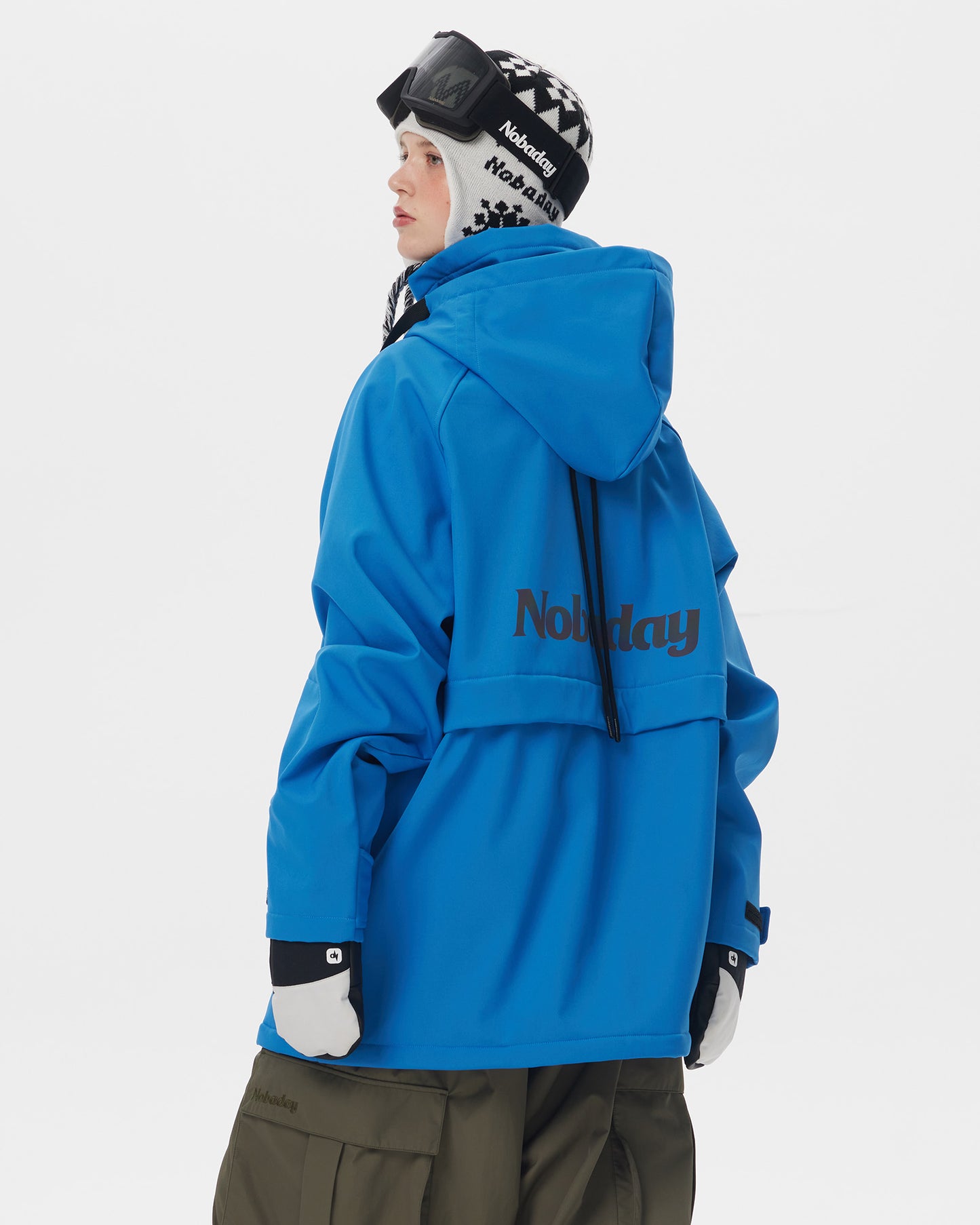 Back view of Nobaday women's blue softshell fleece hoodie showing oversized hood, back logo, relaxed fit, and winter snowboard style