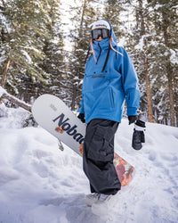 Full body view of Nobaday women's blue softshell fleece snowboard hoodie with oversized fit, high collar, and snow pants