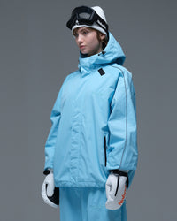 Side view of the NOBADAY Women's Dawn OG Insulated ice blue snow jacket showing its oversized fit, storm hood, and zippered pocket