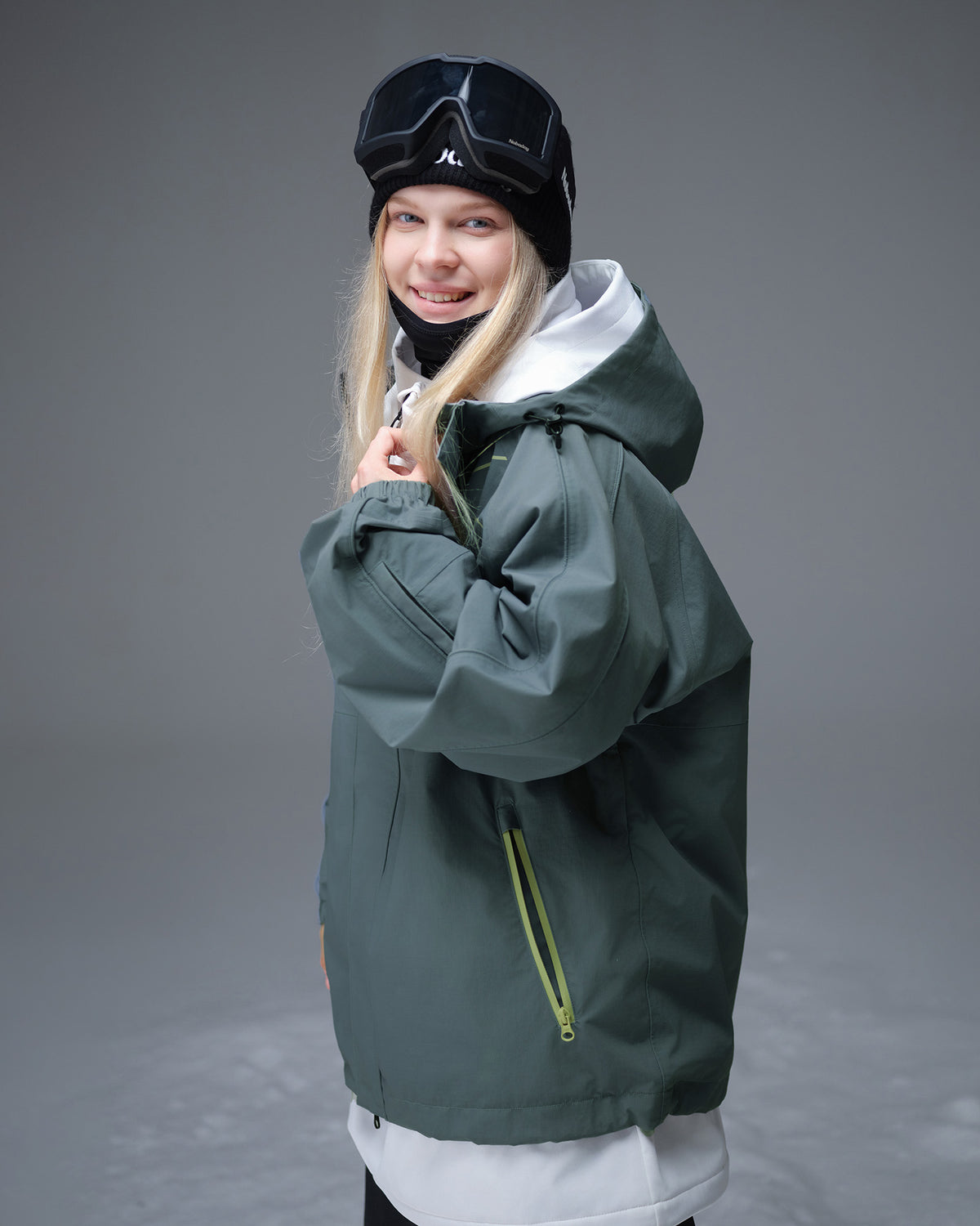Side view of Nobaday Women's Pure Free Active green snow jacket with adjustable hood, oversized sleeves, and functional pockets