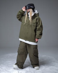 Full body layered look of Nobaday women's green cargo snow jacket with matching snow pants, goggles, and relaxed snowboard fit