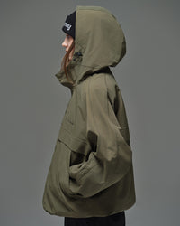 Side detail view of Nobaday women's green cargo snow jacket with oversized hood, adjustable drawcord, sleeve seam, and relaxed fit