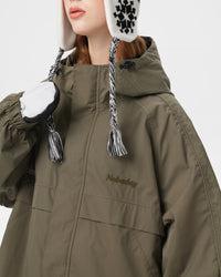 Detail of Nobaday Women's Pure Free green snow jacket high collar, hood adjuster, storm flap, and embroidered logo