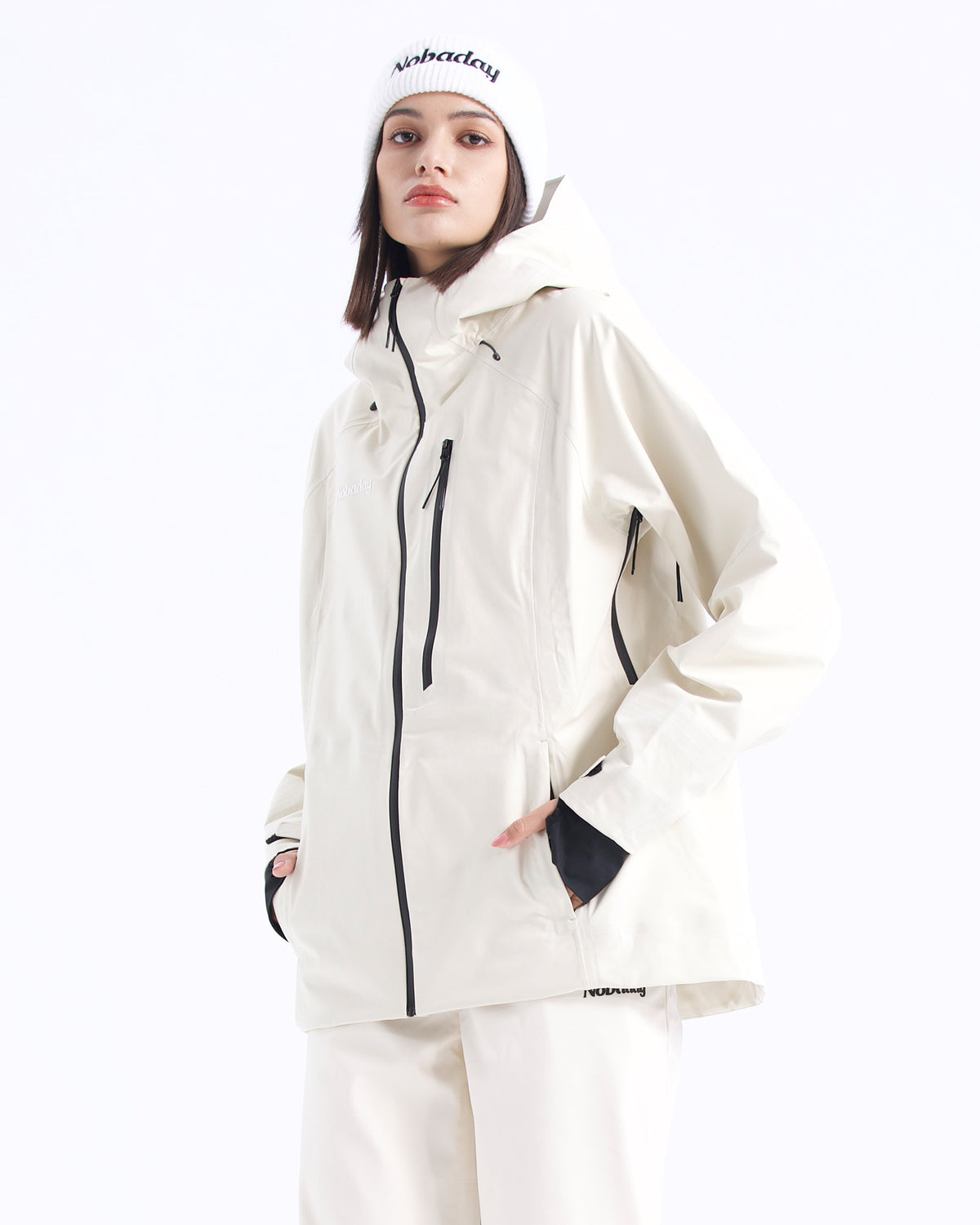 Half-body pose of a woman wearing the NOBADAY Women's Juicy 3L white waterproof snow jacket with a hood and black zippers