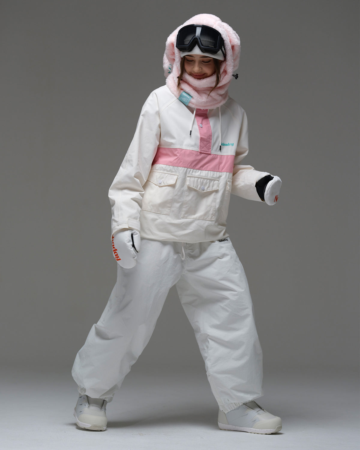 Full-body action view of a model wearing the ivory and pink Nobaday Women’s Juicy Candy Retro Snow Jacket