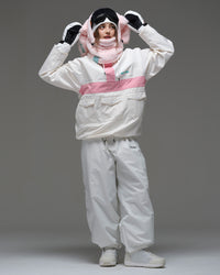 Full-body view of a model wearing the ivory and pink Nobaday Women’s Juicy Candy Retro Snow Jacket with white snow pants