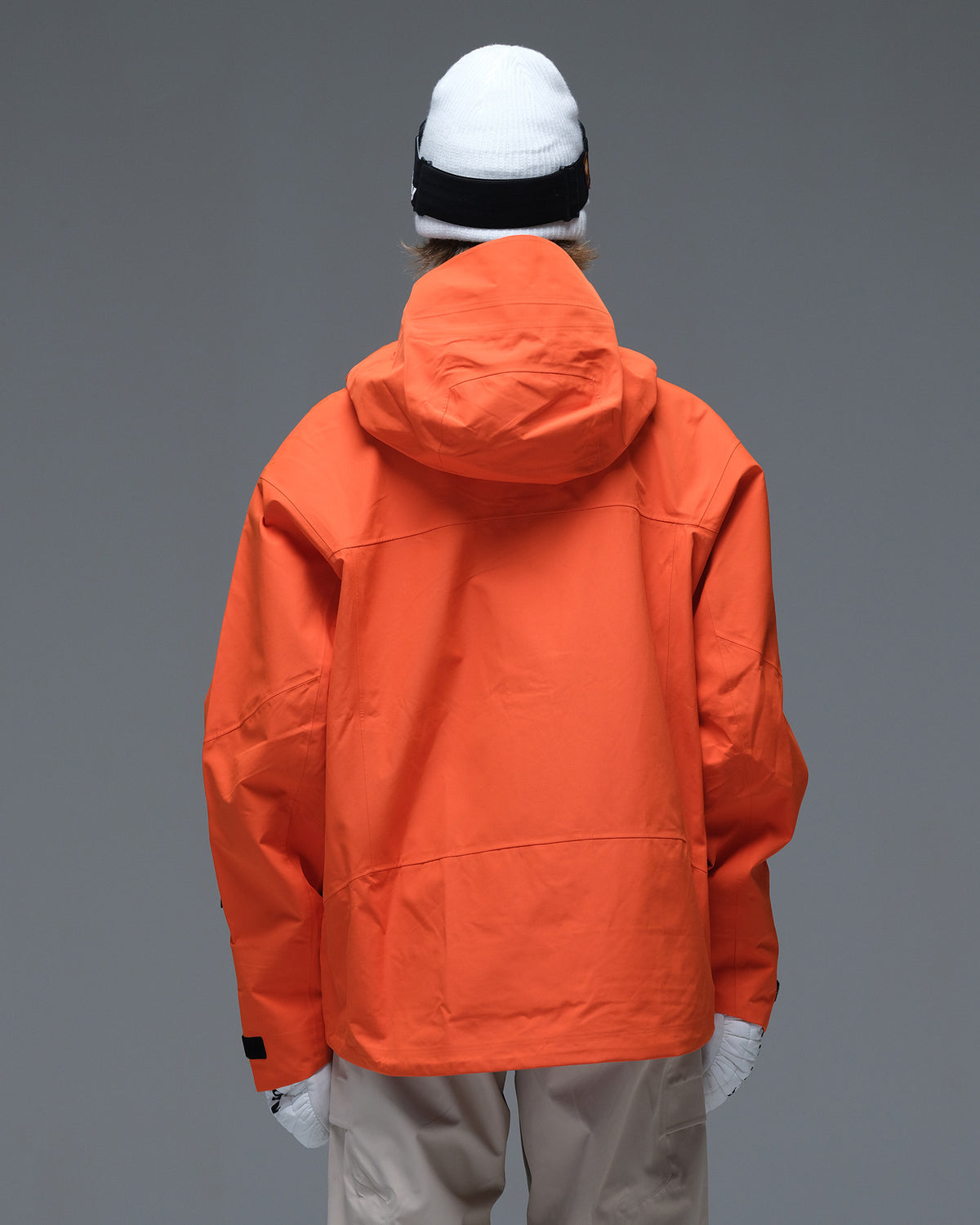 Back view of the orange Nobaday Women’s MaxExtreme Pro Zip-Up 3L Snow Jacket showing its protective hood and streamlined design